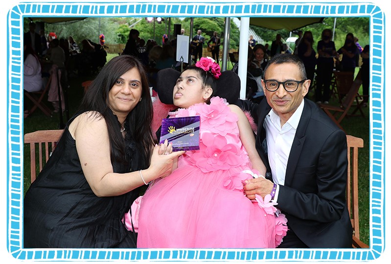 Rhea with her Mum Purabi, posing with her WellChild Special Recognition award! Image courtesy of WellChild.