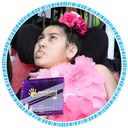 Rhea's with her WellChild award. Image courtesy of WellChild.